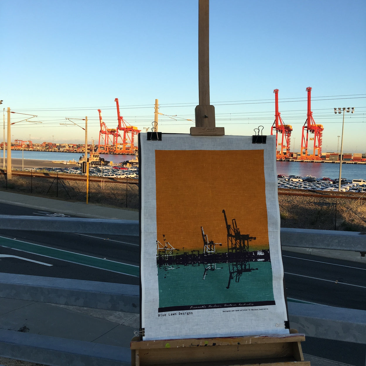 Photo of a Fremantle Harbour tea towel on an easel.