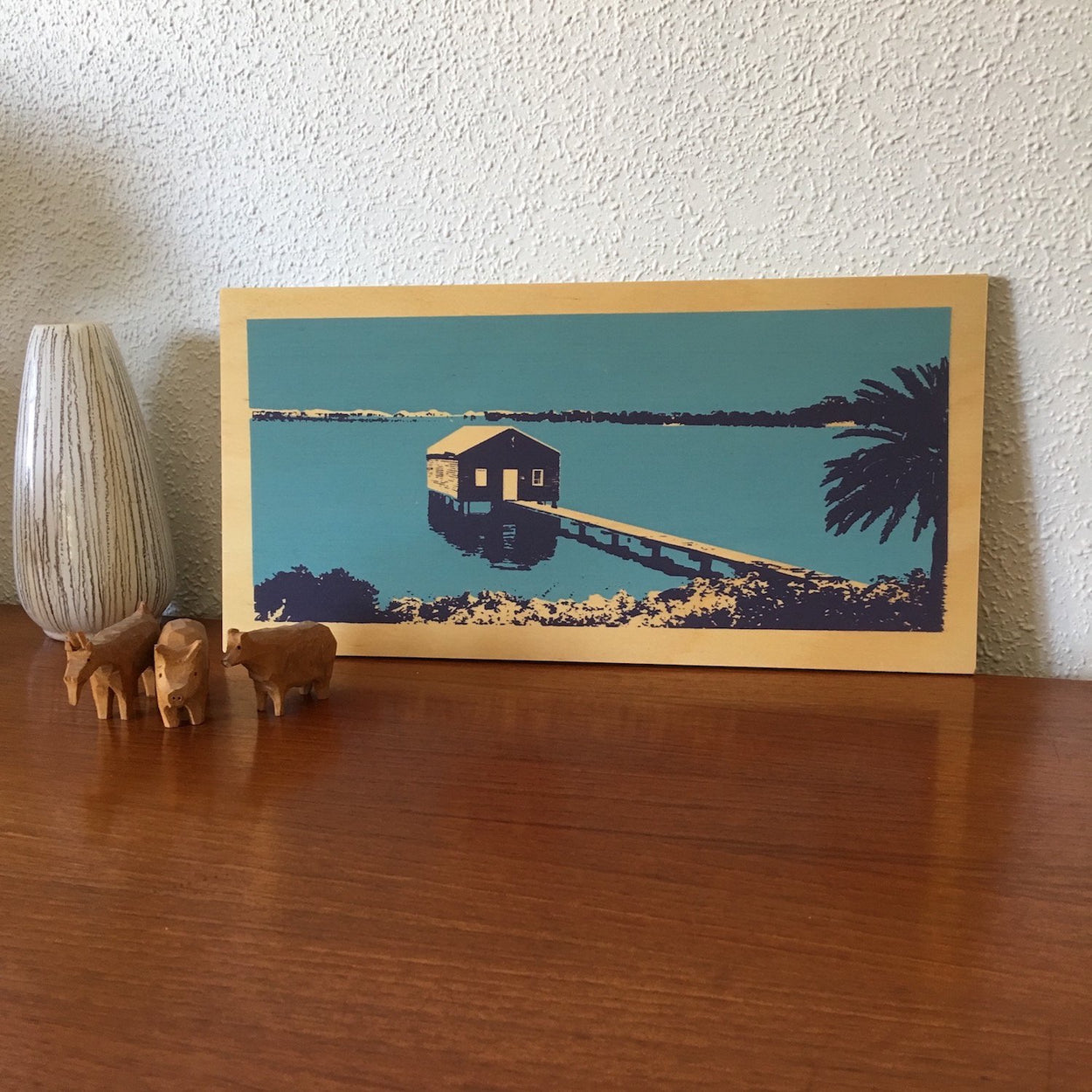 Photo of a blue boathouse on Perth's Swan River, screenprinted on plywood.