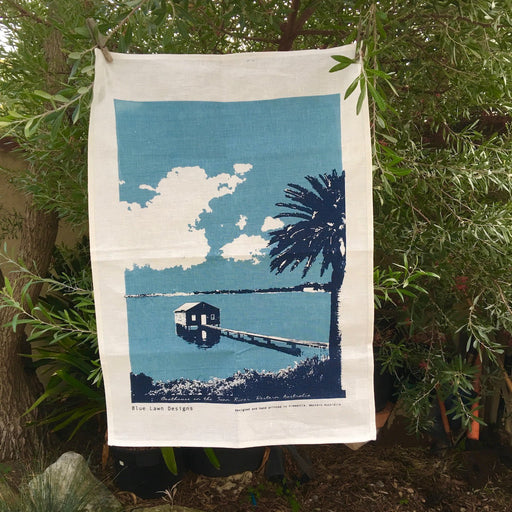 Photo of a boathouse on Swan River screenprinted on a tea towel.