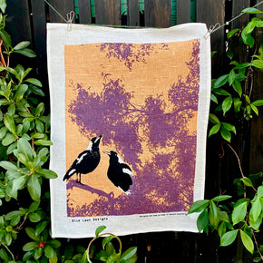 Magpies at dusk tea towel