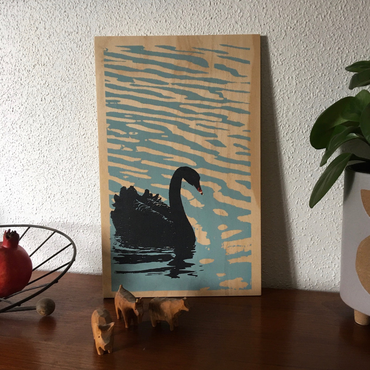 Black swan on plywood