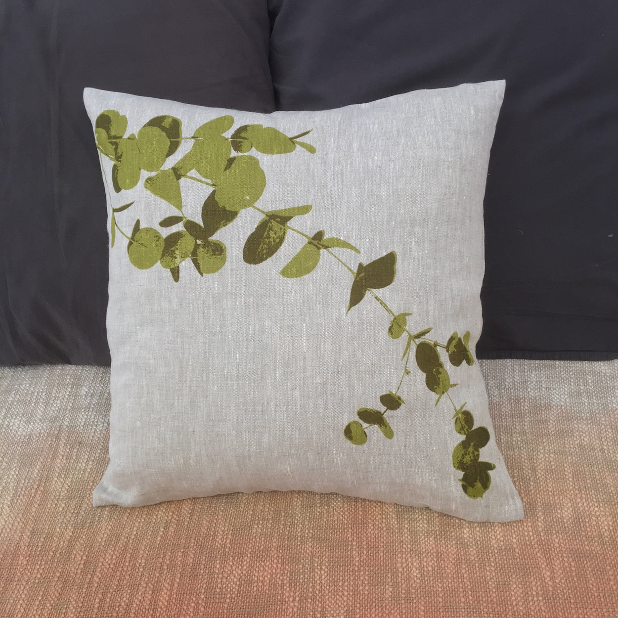 Photograph of eucalyptus leaves screenprinted on a cushion cover.