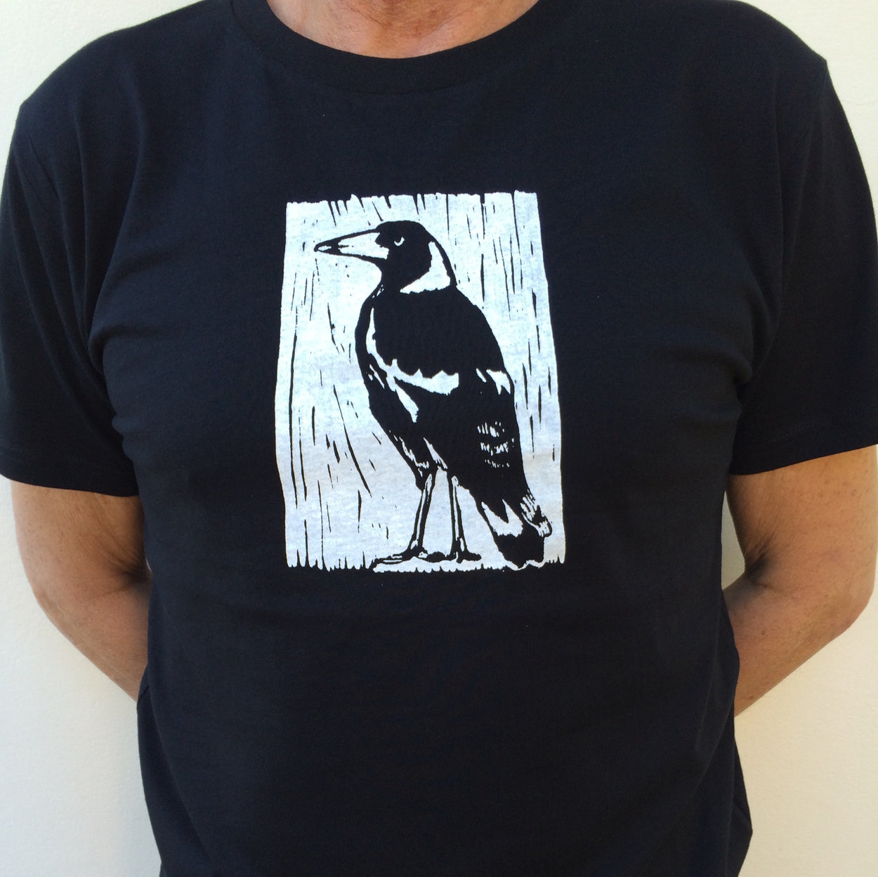 Photograph of screenprinted t-shirt depicting an Australian Magpie.