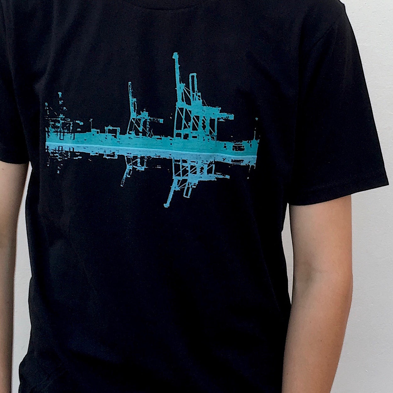 Photograph of screenprinted t-shirt depicting the container cranes at Fremantle Harbour.
