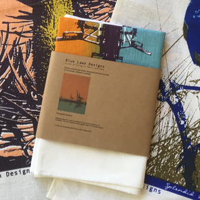 Photograph of screenprinted tea towels packaged.