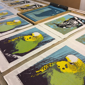 Photograph of linen tea towels being screenprinted.