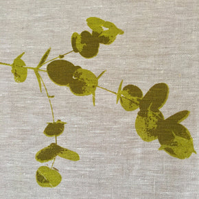 Photograph of eucalyptus leaves screenprinted on linen in close-up.