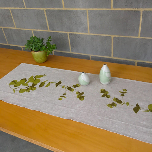 Photograph of gum leaves screenprinted on a table runner.