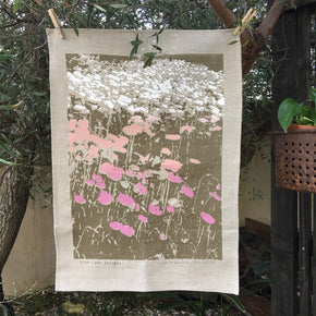 Photo of Everlasting daisies screenprinted on a tea towel.