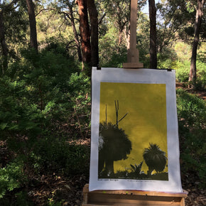 Photograph of a grass trees tea towel on an easel in the forest.