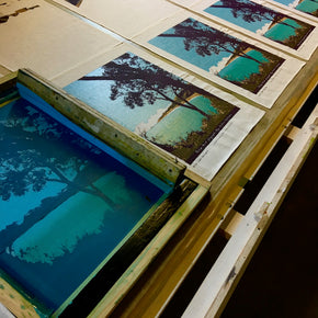 Photograph of linen tea towels being screenprinted.